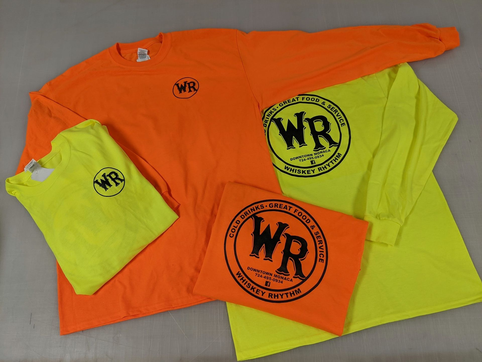 A group of wr shirts are sitting on a table