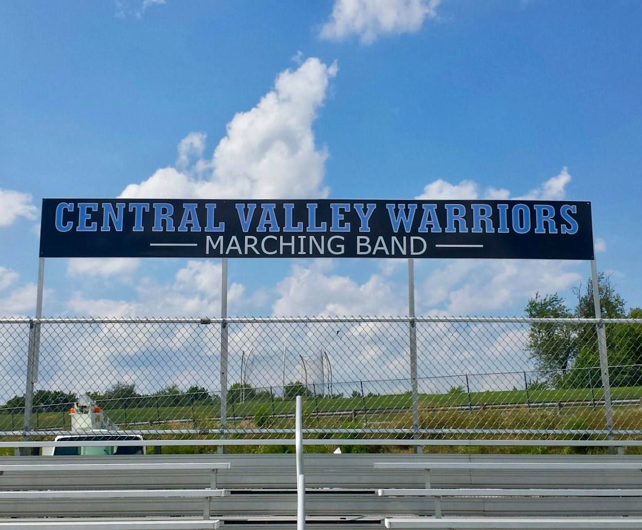 A sign for the central valley warriors marching band