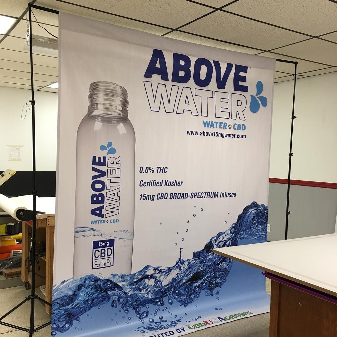 A bottle of above water is on display in a room