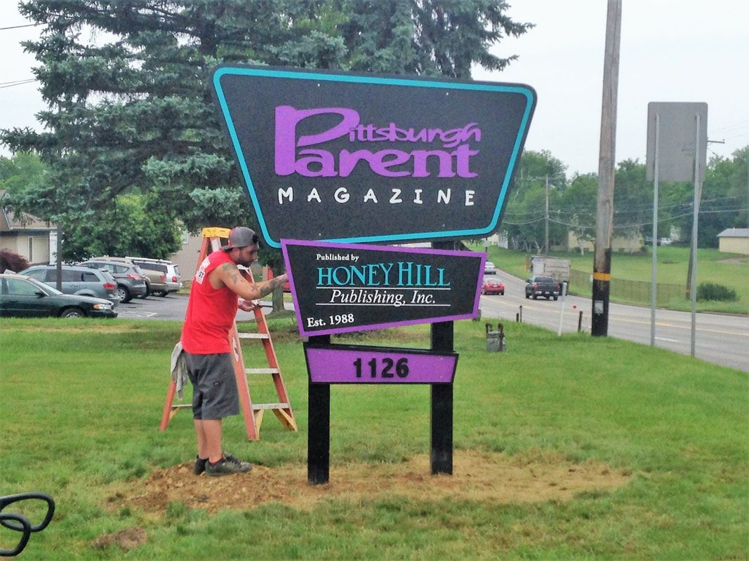 A man is installing a sign for