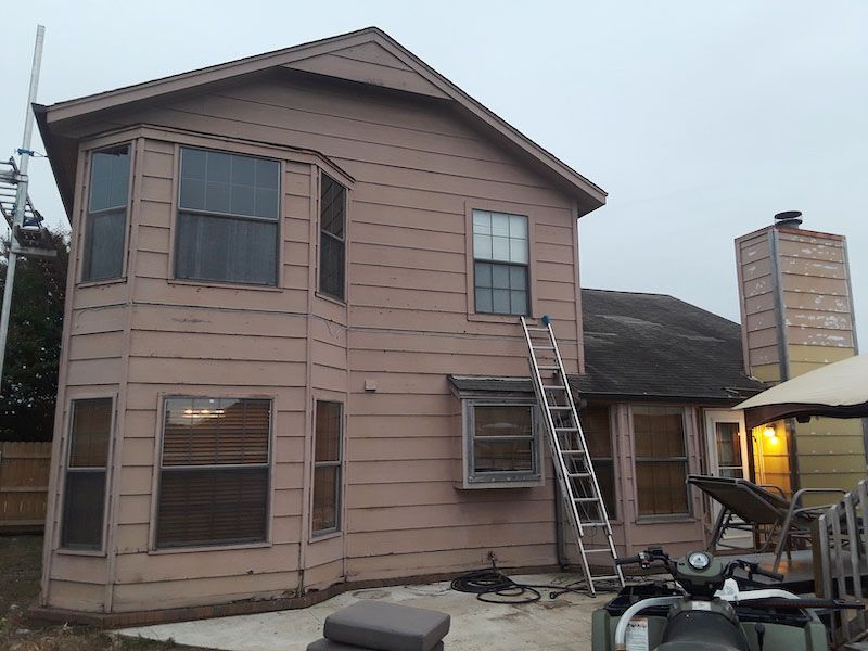 A house with a ladder on the side of it