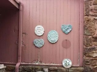 A pink wall adorned with heart-shaped plates.