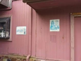 Pink wall with posters.