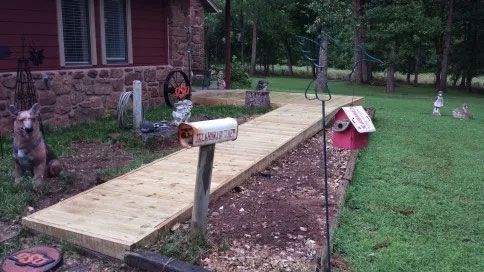 A garden with a wooden walkway.
