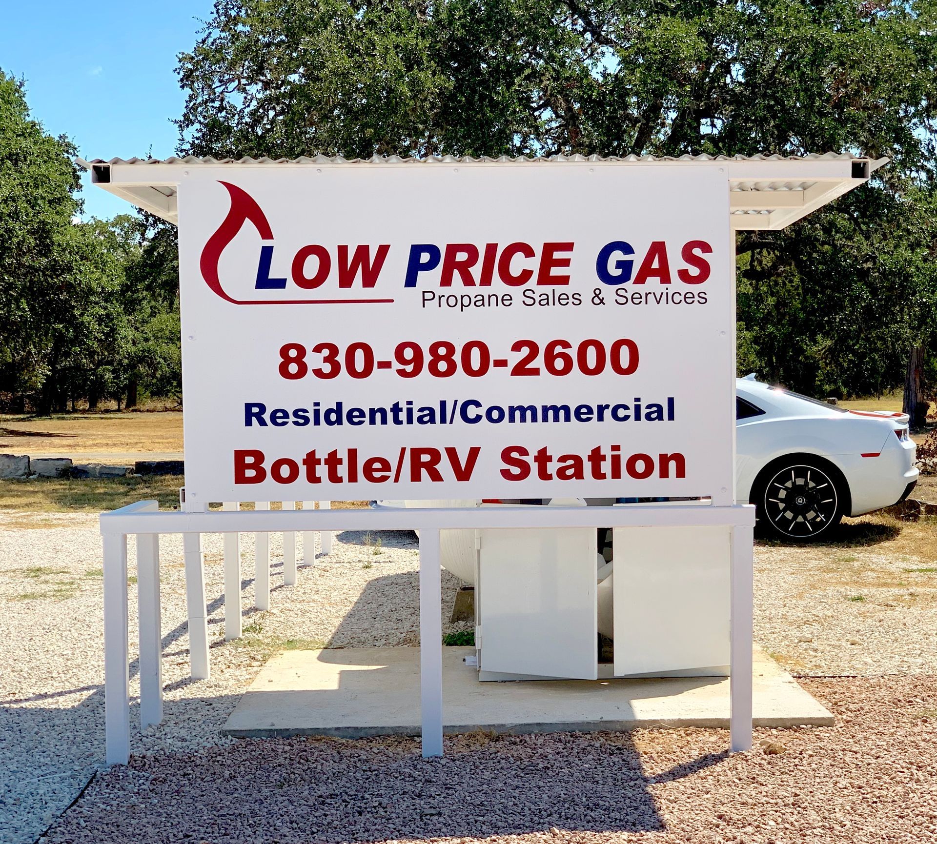 Low Price Gas sign for residential, commercial, bottle and RV station with phone number outdoors