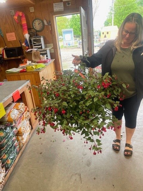 A woman is holding a bunch of flowers in her hands