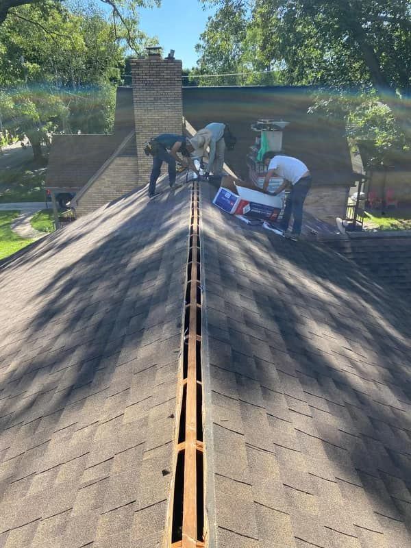 A group of people are working on a roof.