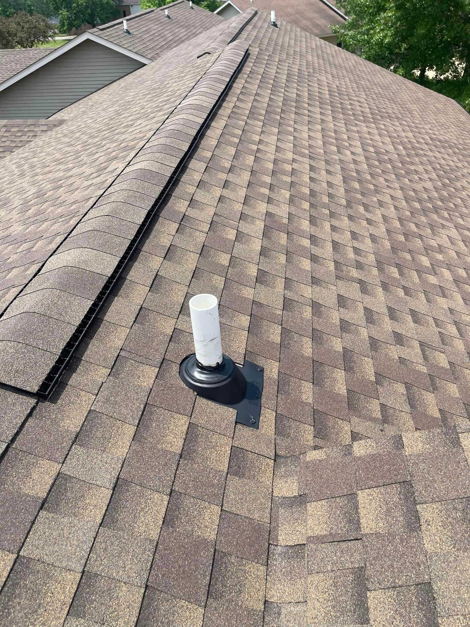 A close up of a roof with a pipe on top of it.