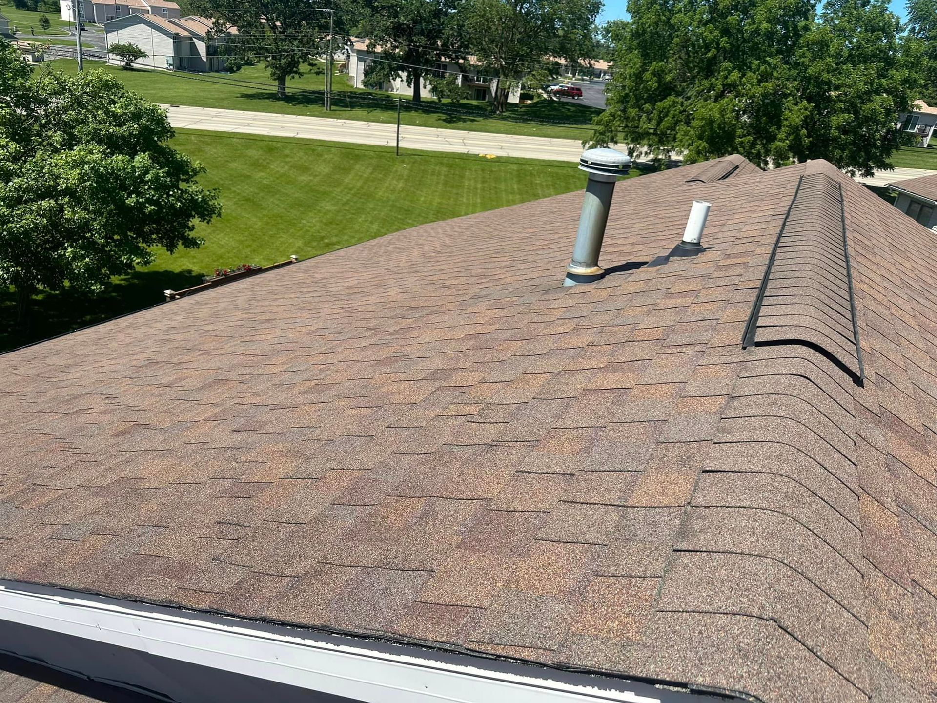 The roof of a house with a chimney on top of it.