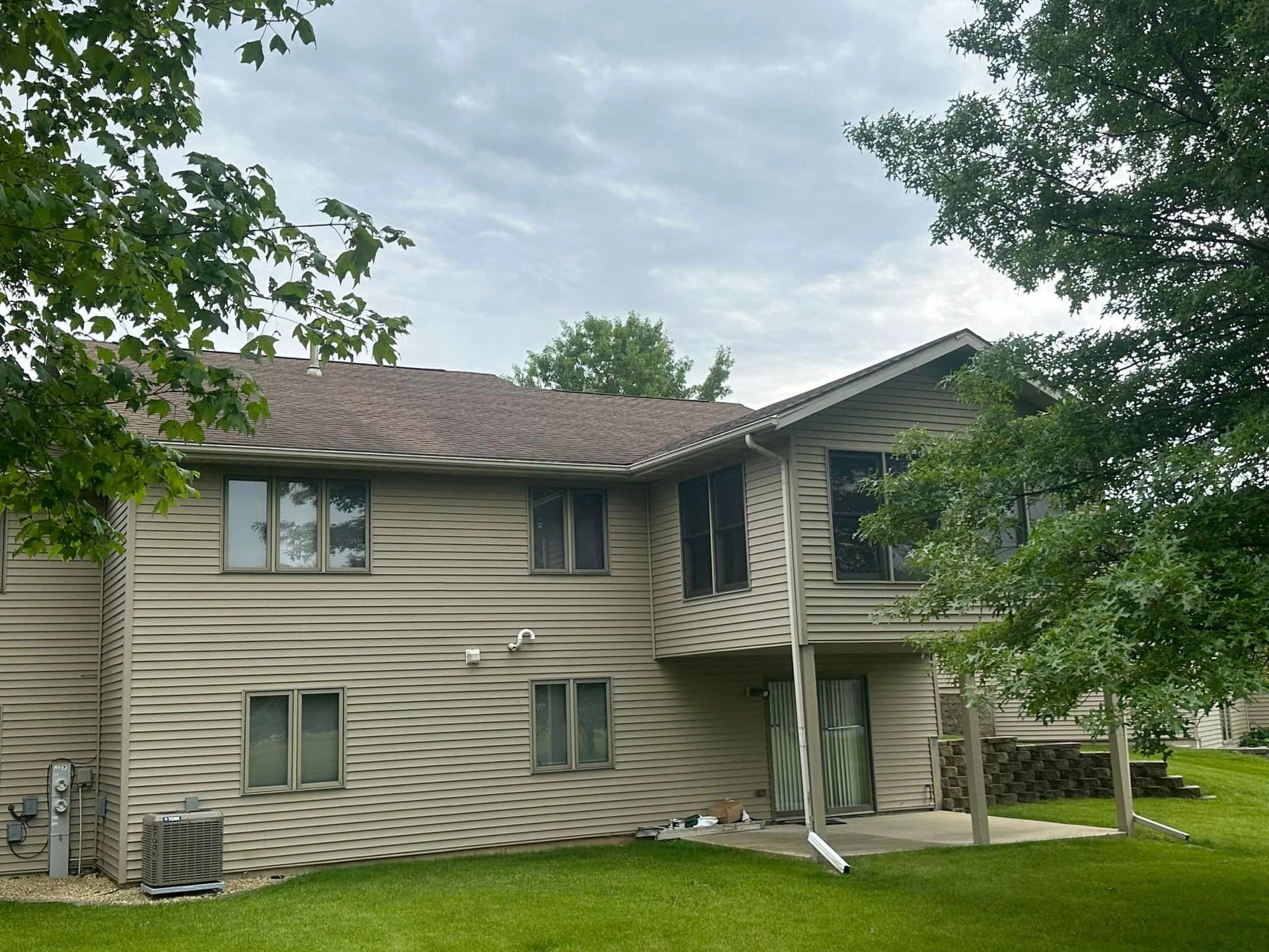 A large house with a lot of windows and a lawn in front of it