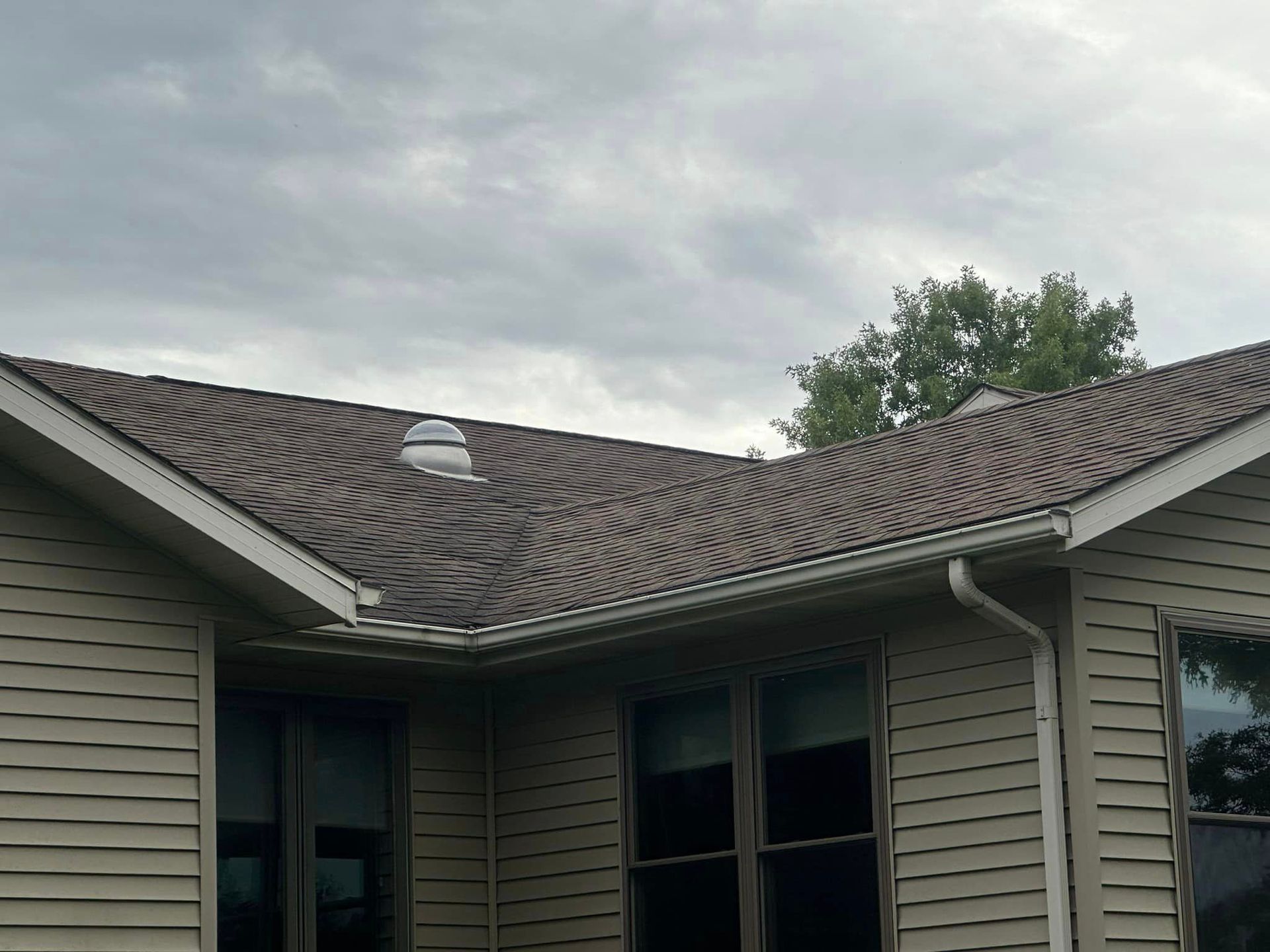 A house with a roof that has a skylight on it.