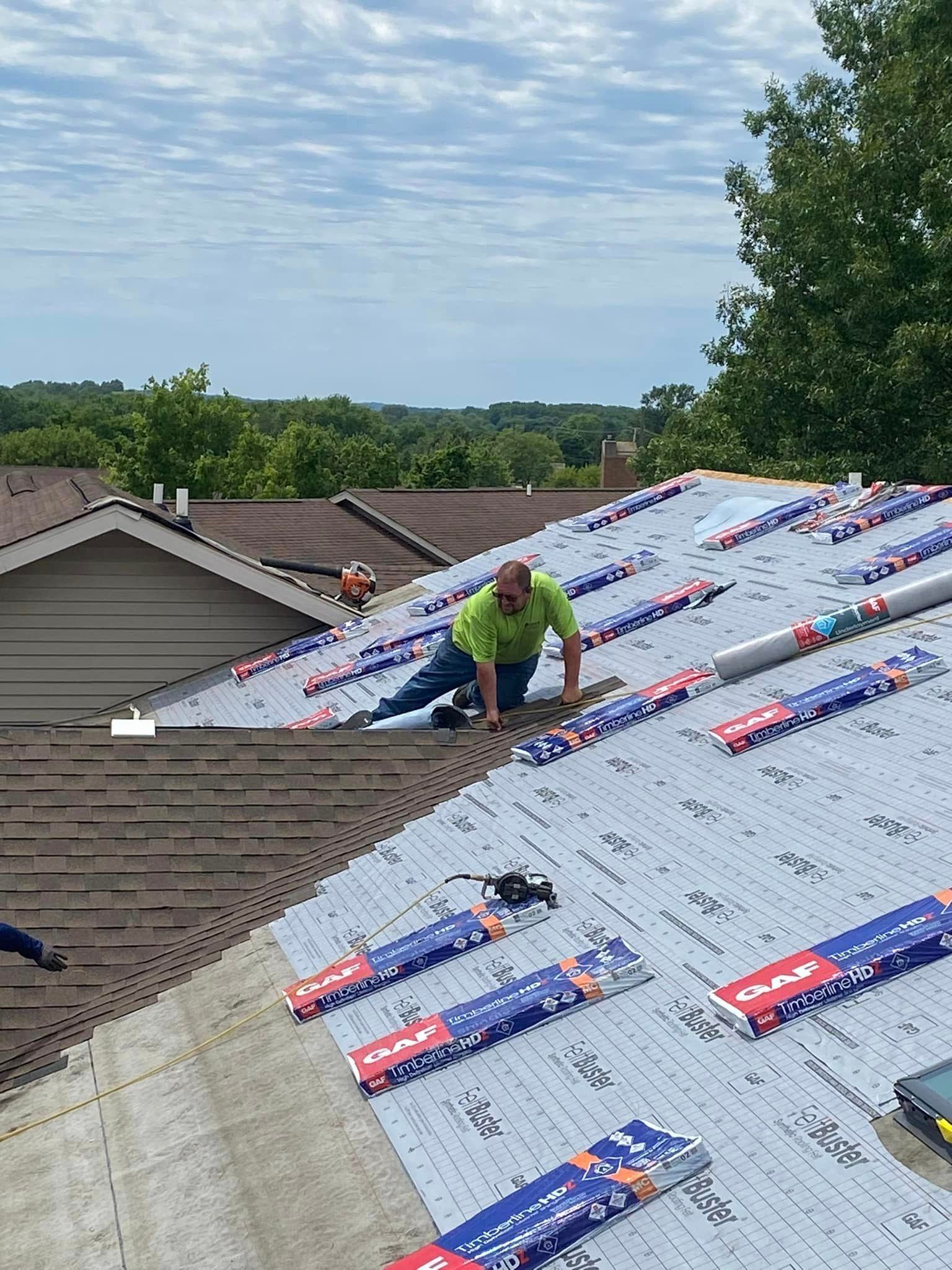 A man is working on the roof of a house.