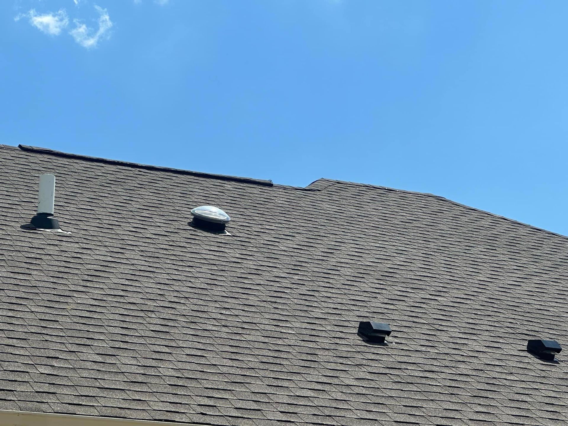 A close up of a roof with a blue sky in the background.
