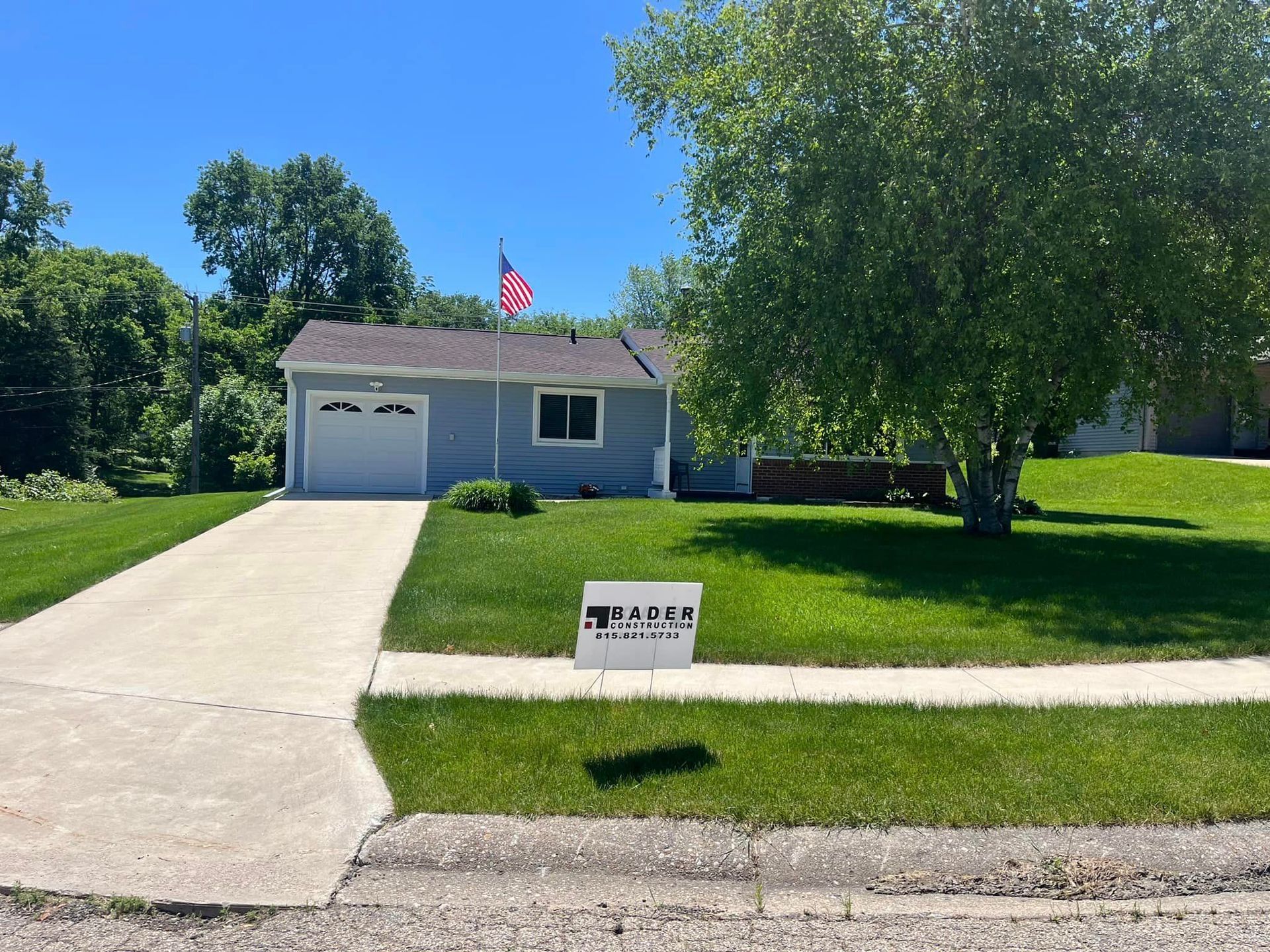 A house with a sign in front of it.