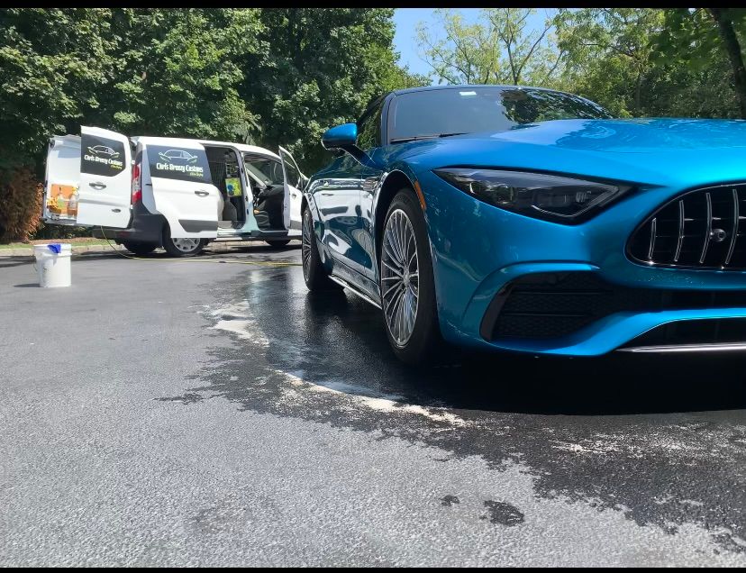A blue and yellow van is parked on the side of the road.