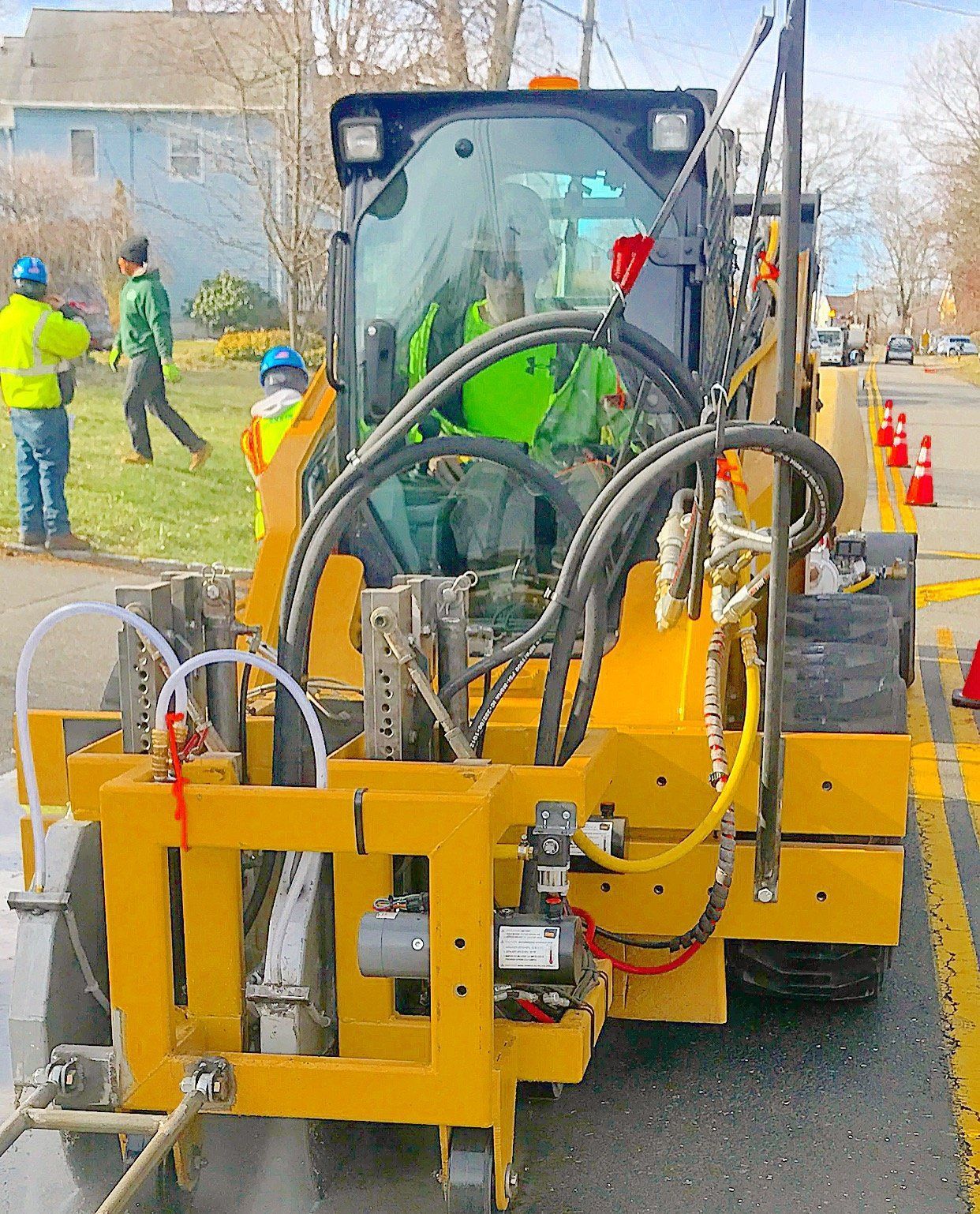 Yellow tractor on the side of the road