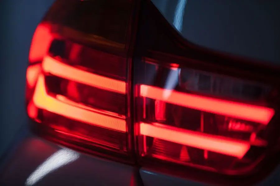 Close-up of a car’s red taillights glowing in the dark