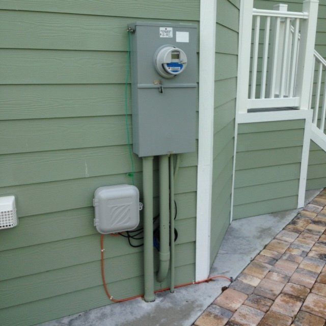 A meter on the side of a green house