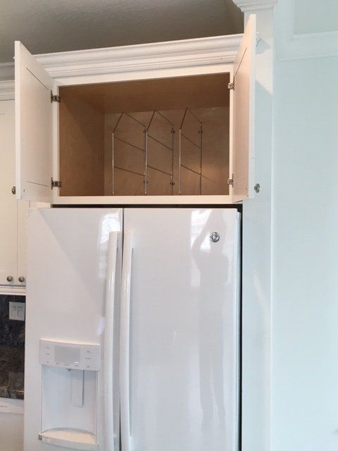 A white refrigerator in a kitchen with the door open