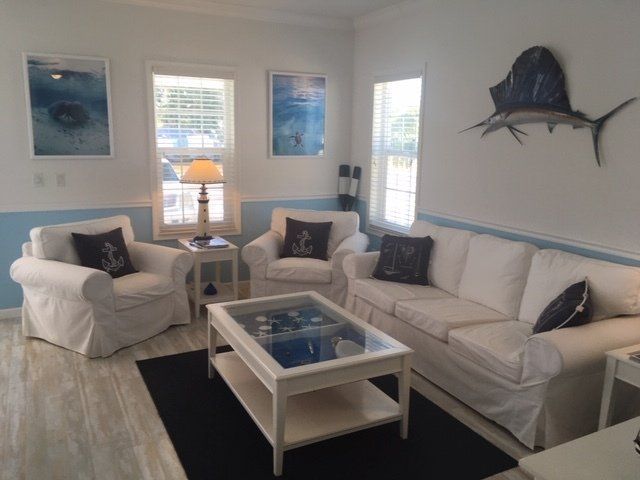 A living room with a couch and two chairs