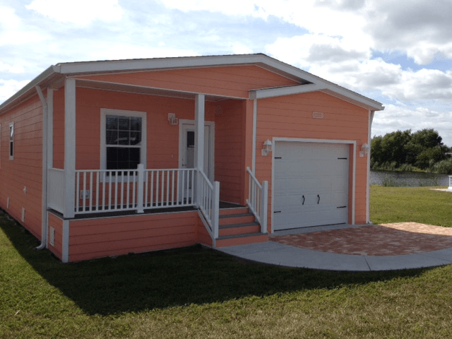 A small house with a garage and a porch