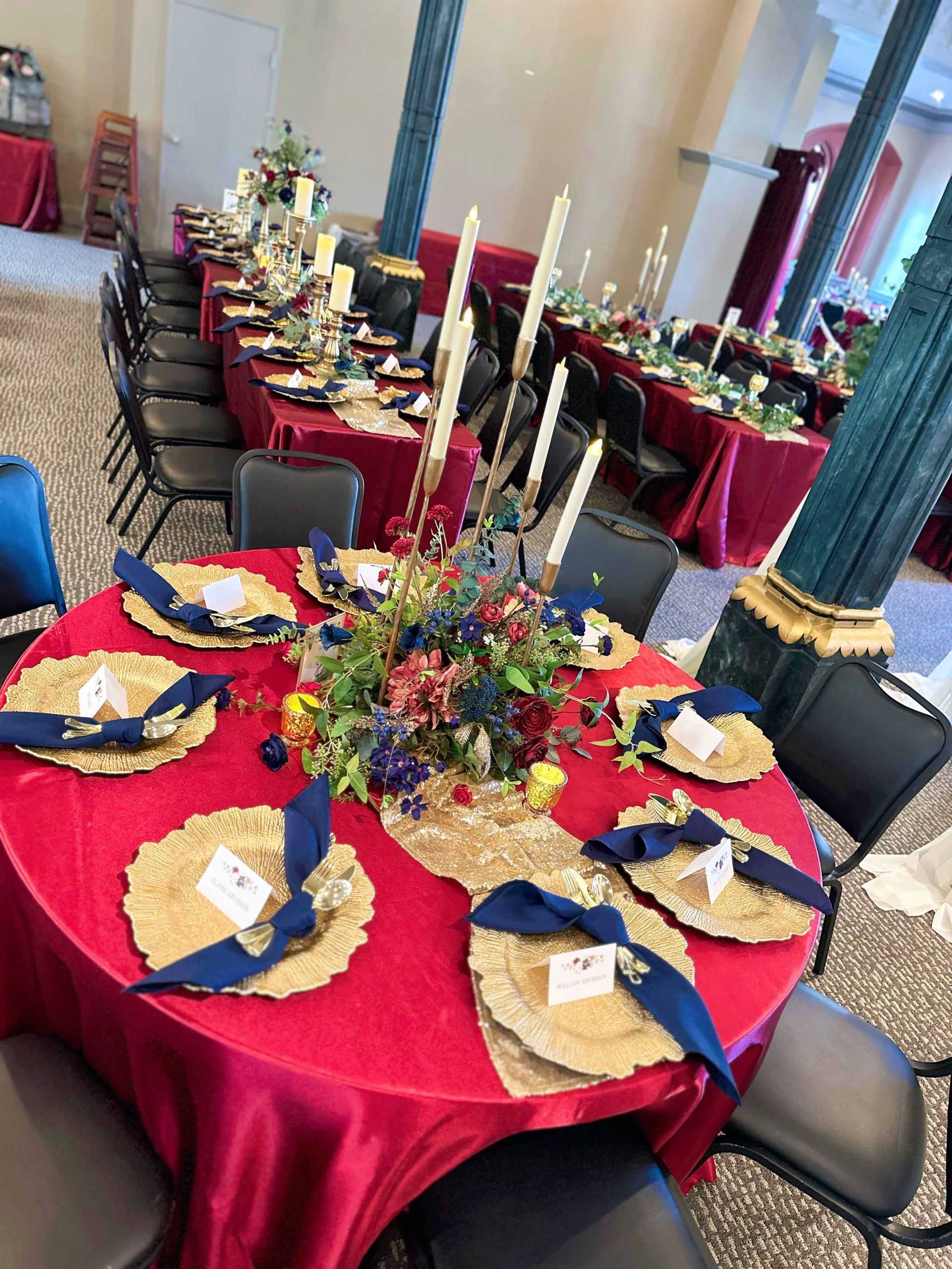 A large room with tables and chairs set up for a party.