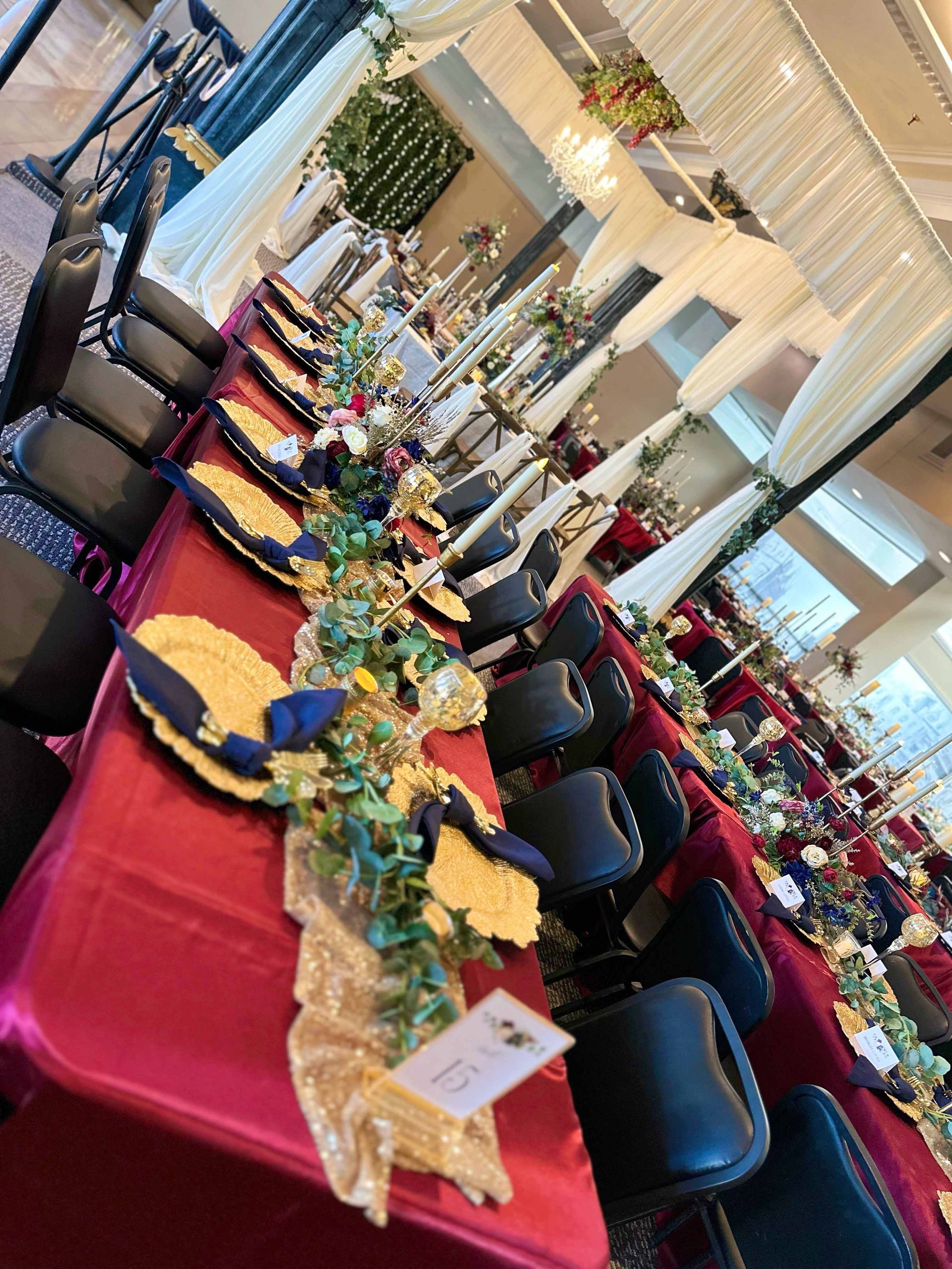 A long table with plates and napkins on it in a room.