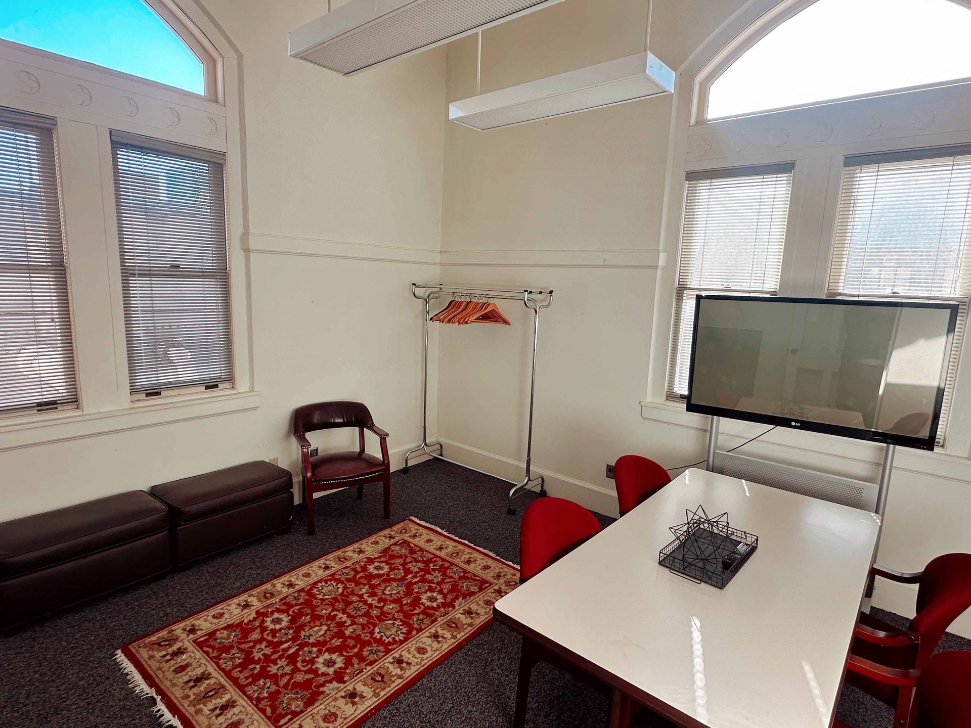 A room with a table and chairs and a flat screen tv