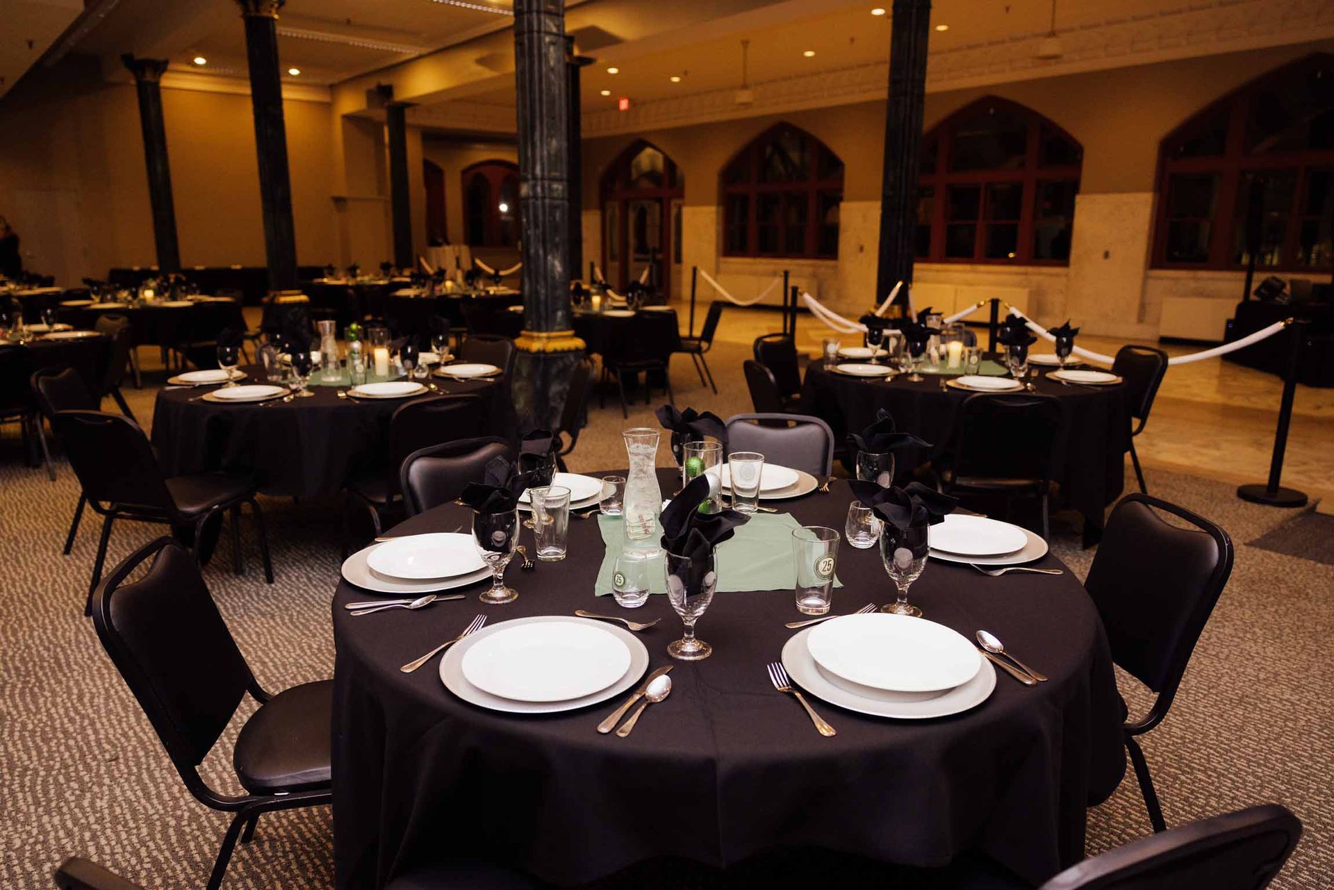 A large room with tables and chairs set up for a party
