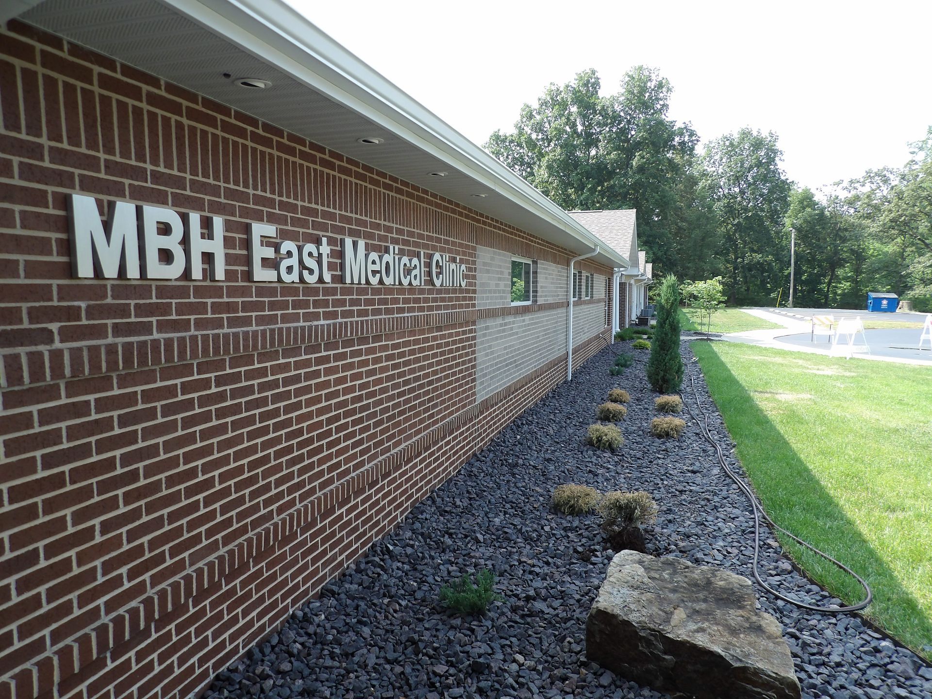 A brick building with a sign that says ' mbh east medical ' on it.