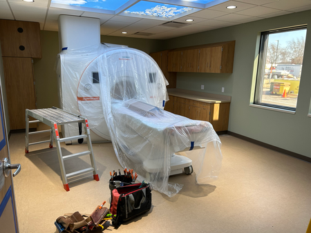 A room with a mri machine covered in plastic.