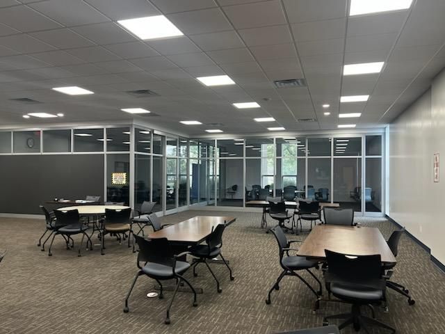 A large room with tables and chairs in it