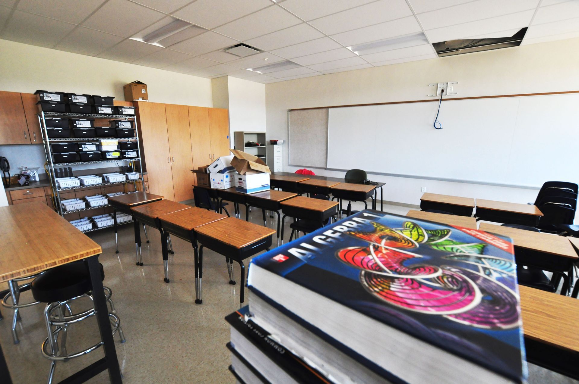 A stack of books in a classroom with a book titled art room