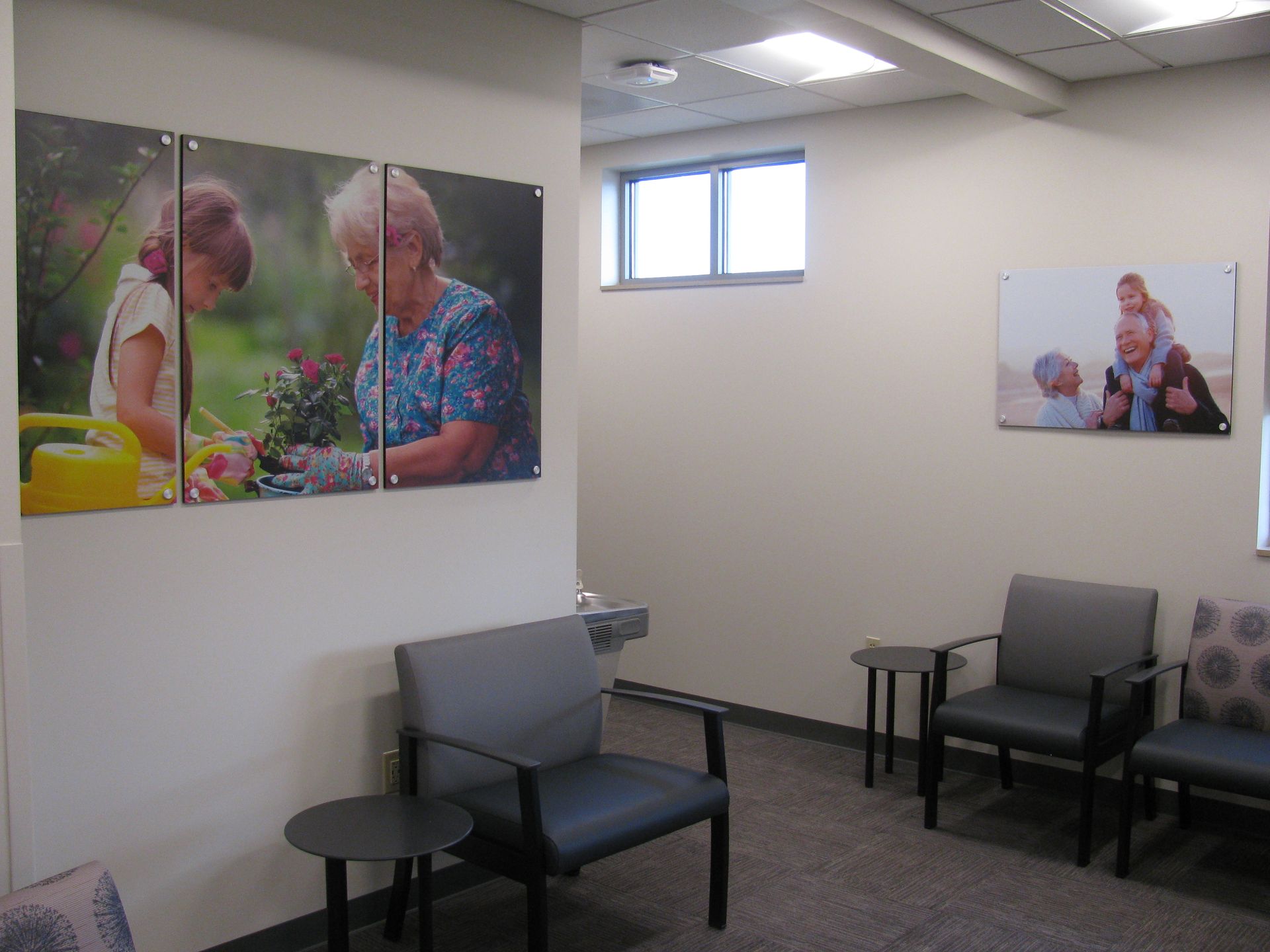 A waiting room with chairs and pictures on the wall