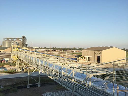 There is a conveyor belt in the middle of a factory.