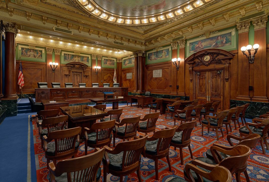 A large room with tables and chairs in it.