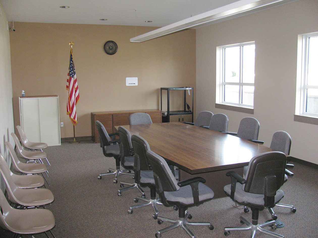 A conference room with a long table and chairs