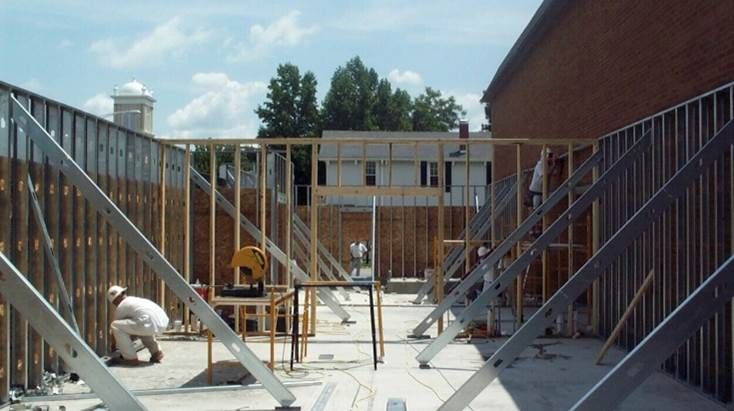 A construction site with a brick building in the background