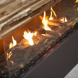 Modern gas fireplace with bright yellow flames and black glass base under stacked logs
