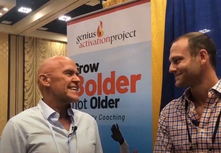 Two men in front of a banner.