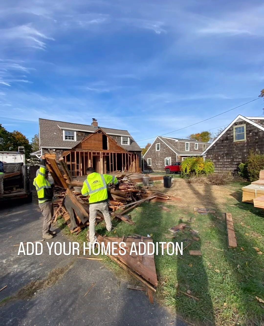 A couple of men are standing in front of a house under construction.