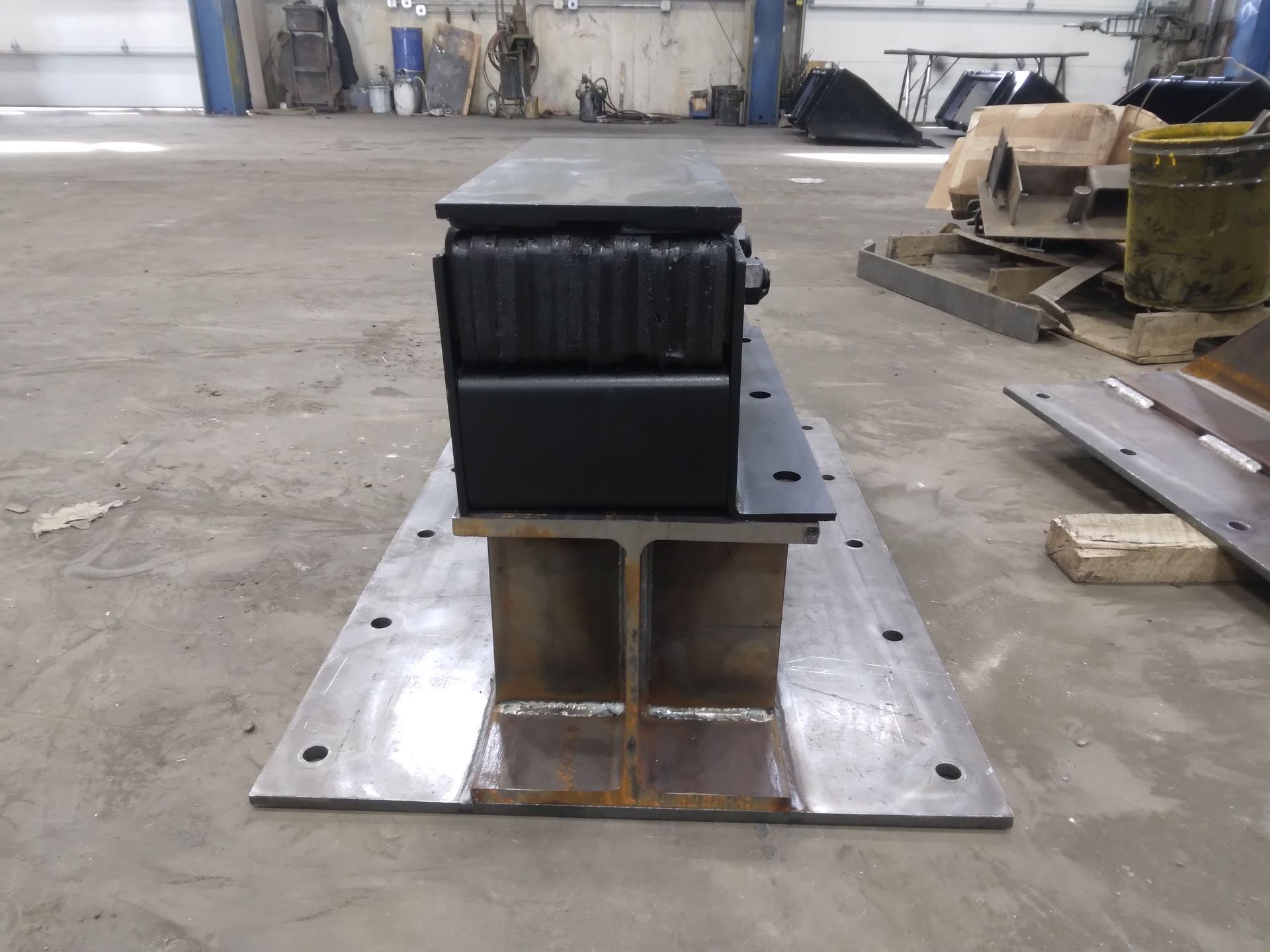 A black box is sitting on top of a metal beam