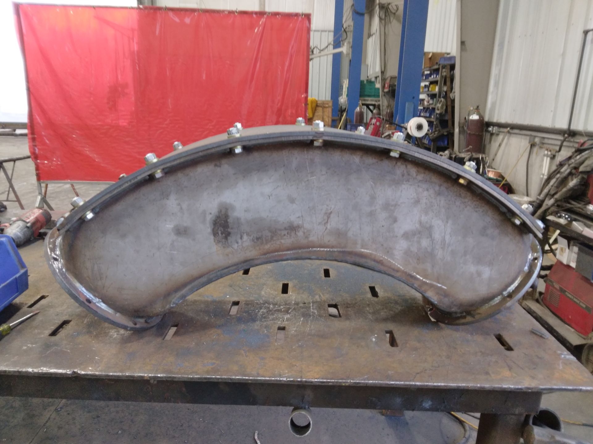 A piece of metal is sitting on top of a welding table.