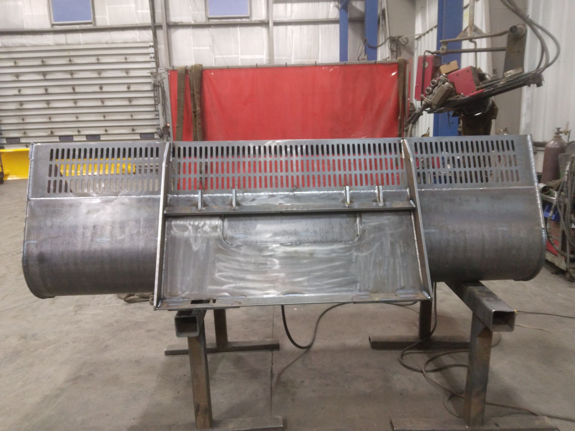 A large piece of metal is being worked on in a factory