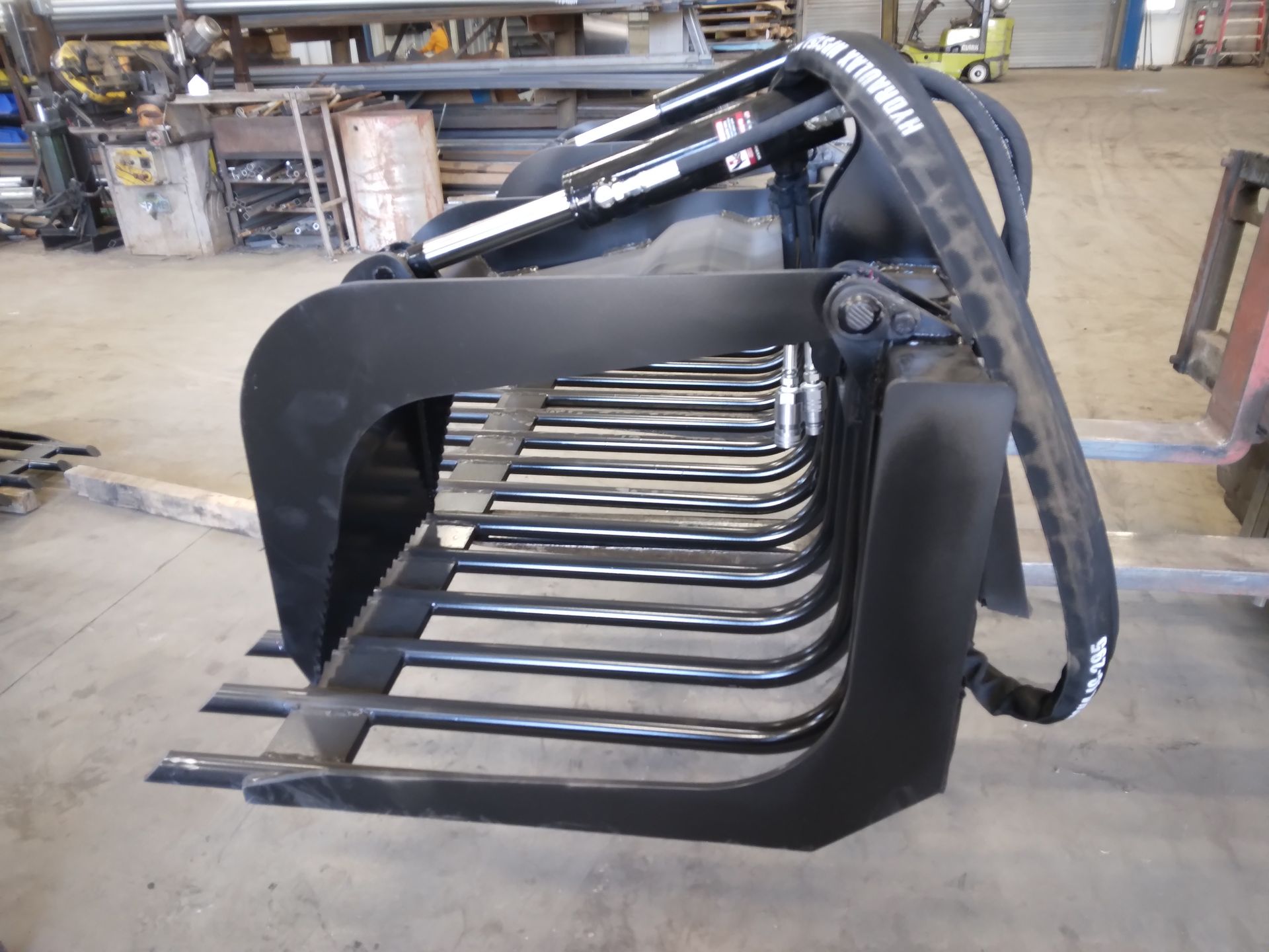 A black bucket with a hose attached to it