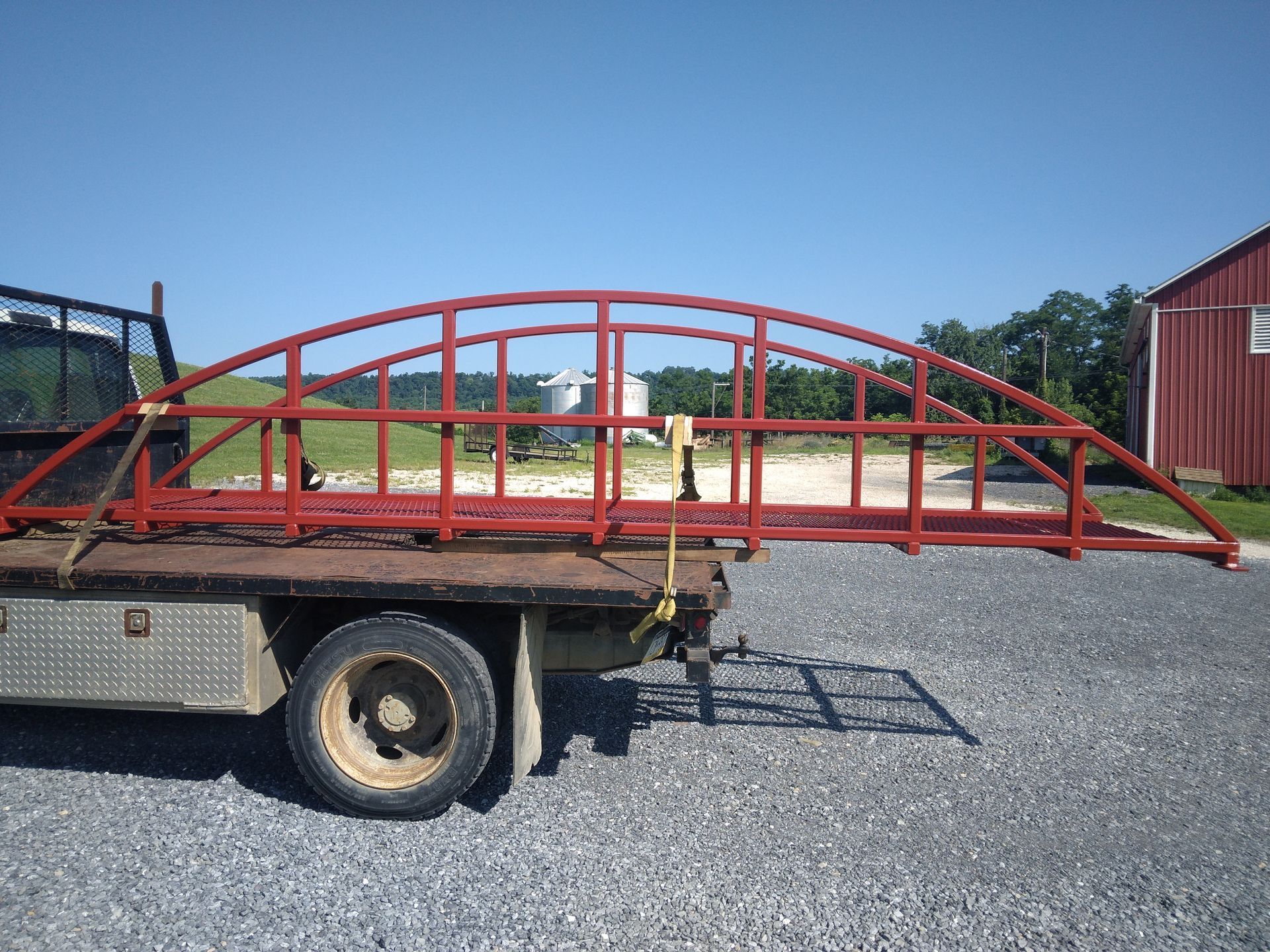 A truck with a red bridge on the back of it