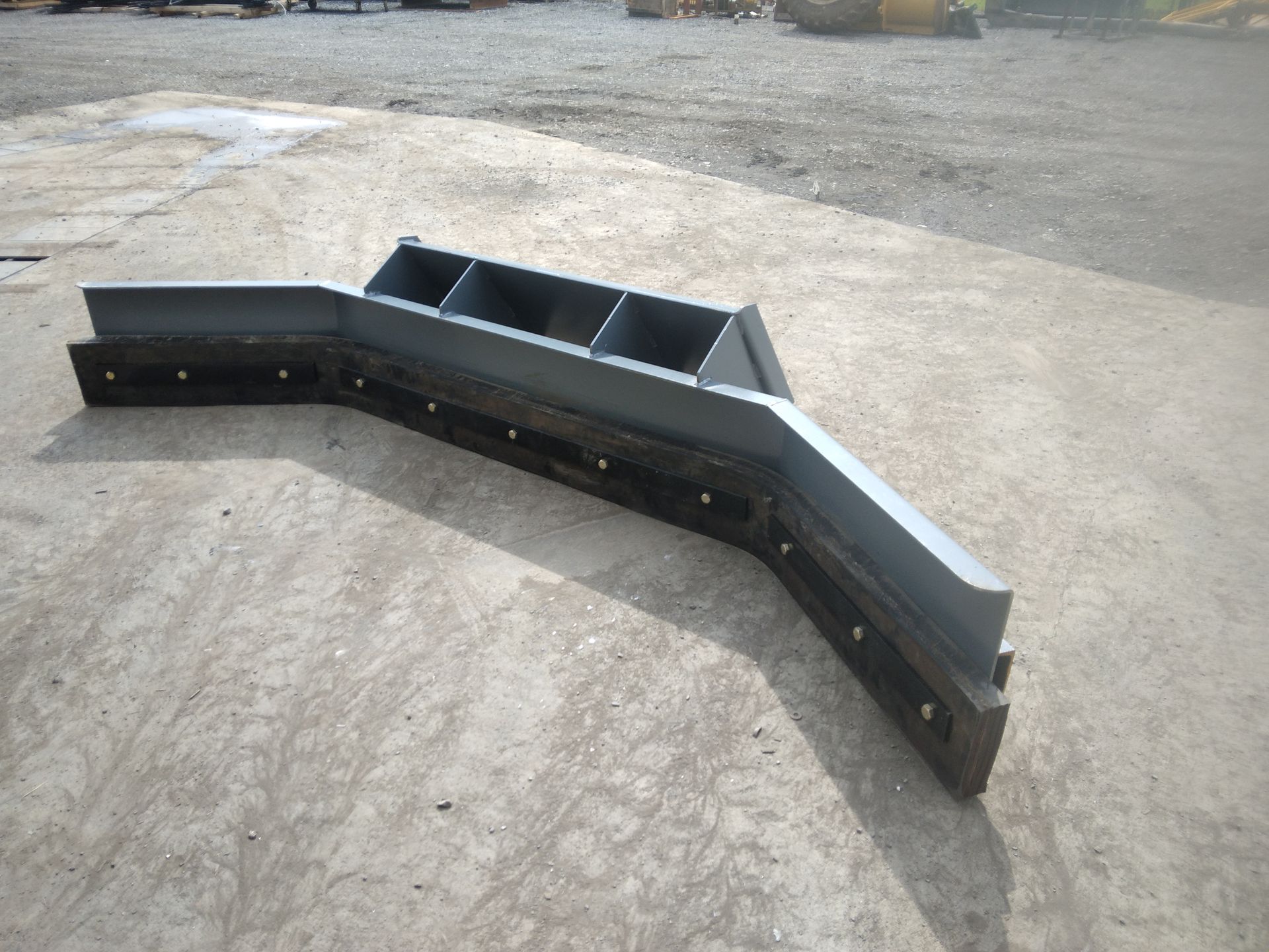 A piece of metal is sitting on a concrete surface