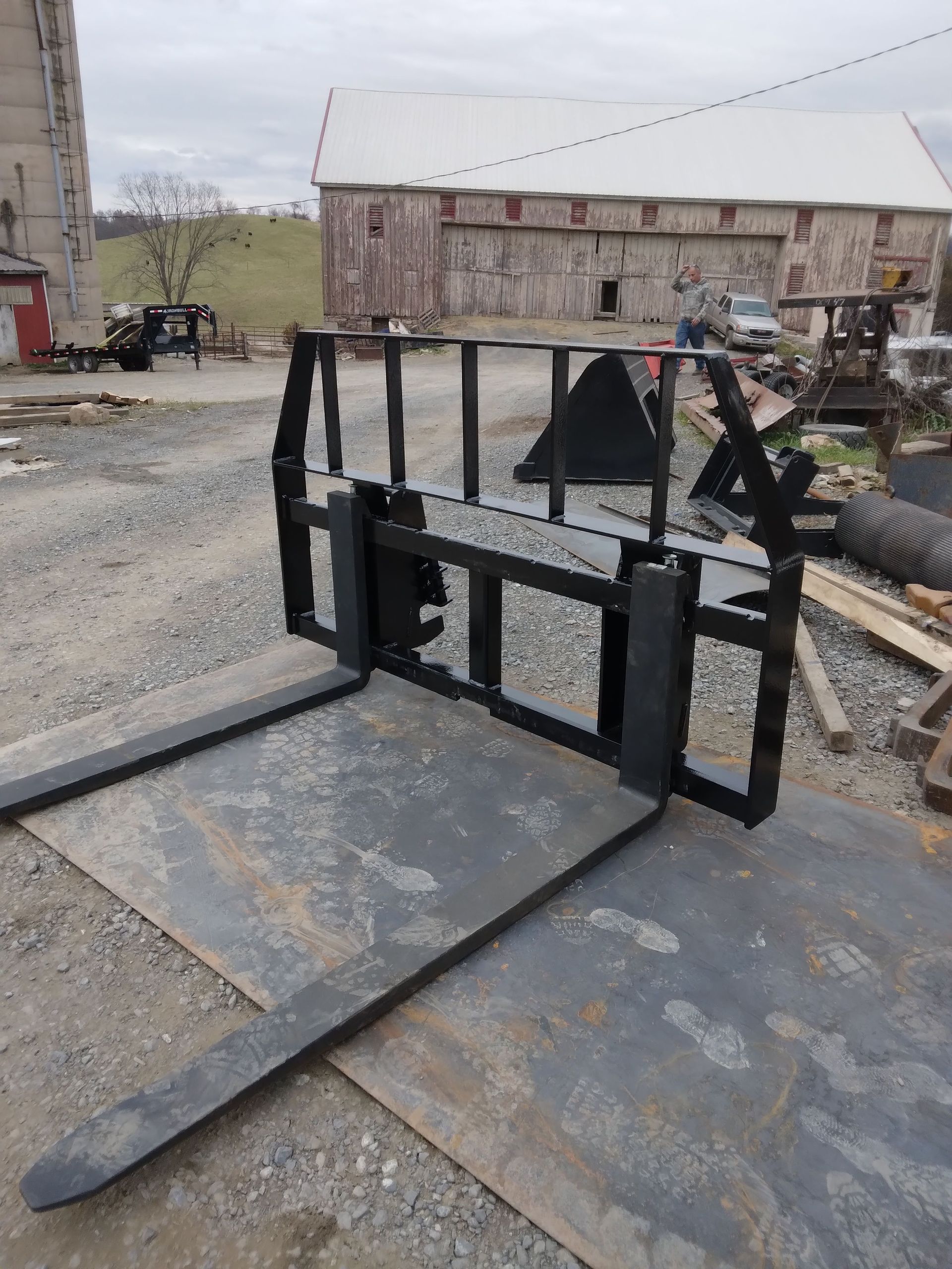 A pair of forks sitting on top of a piece of metal