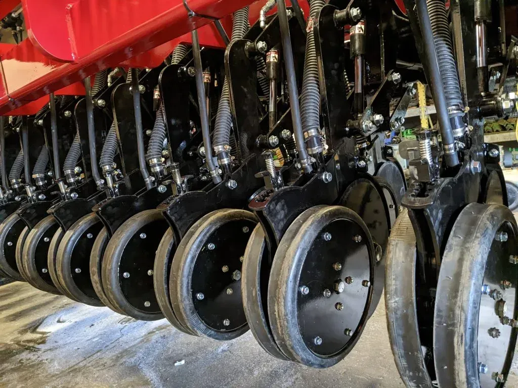 A close up of a row of wheels on a machine.