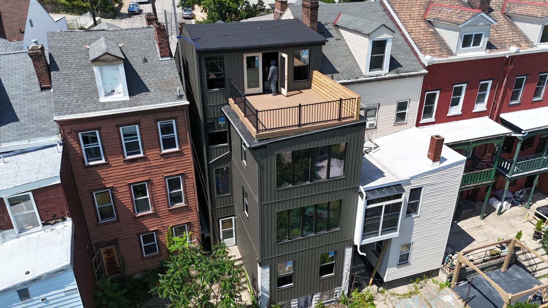 An aerial view of a row of houses with a roof that is being built.